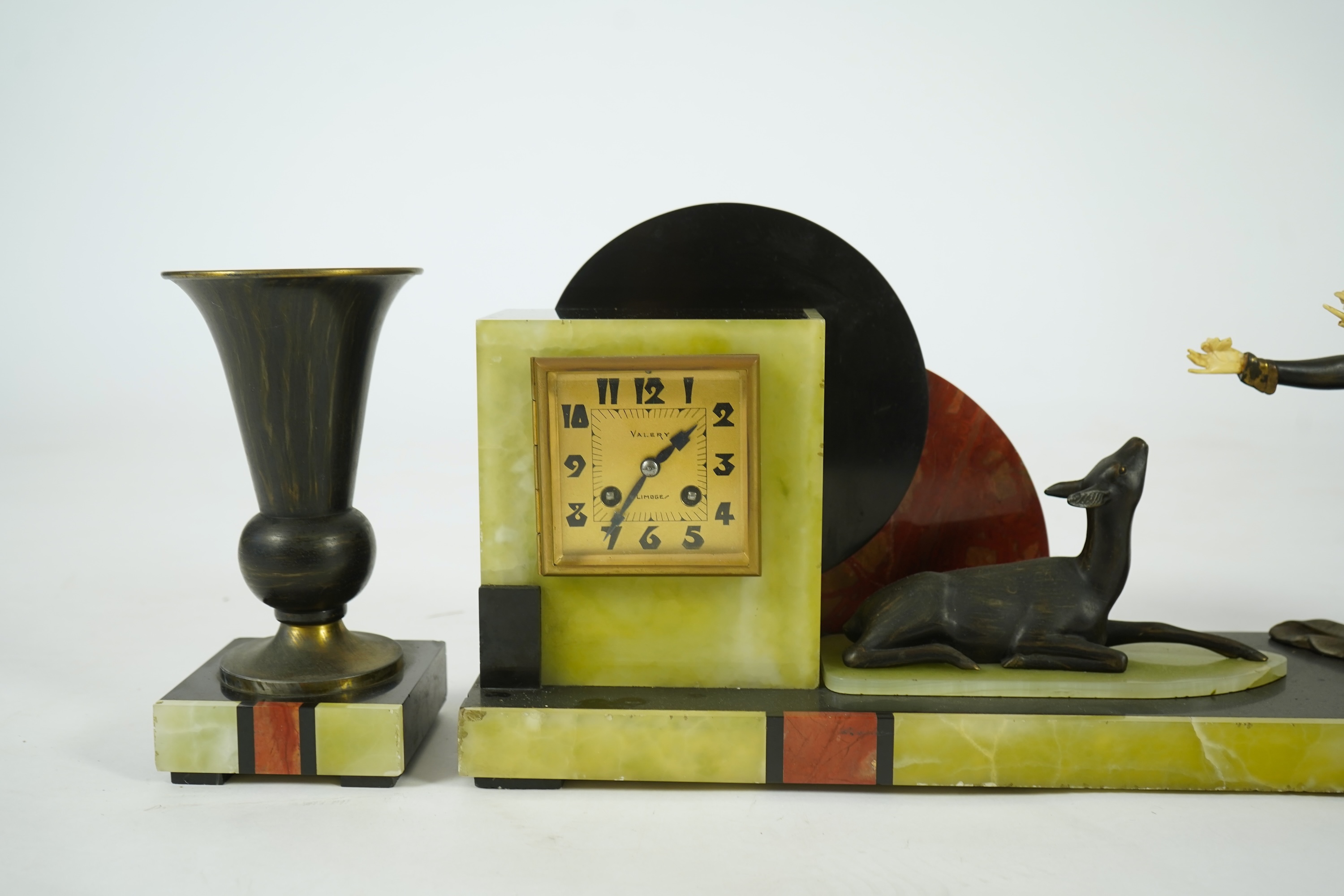 Attributed to Uriano (Ugo Cipriani, Italian, 1897-1960), a Belgian black marble, Rosso red marble and green onyx clock garniture